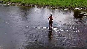 Russian mature woman bathing nude outdoors, revealing her alluring form