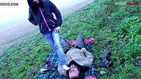 Mistress commands slave to lick feet outdoors in the country