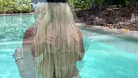 Big tit blonde teases pussy in public pool