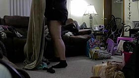 Chubby woman in shorts cleans the house