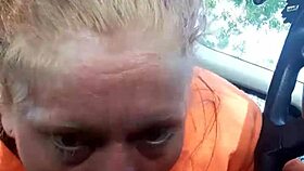 Street whore gives car blowjob with tits and ass exposed.