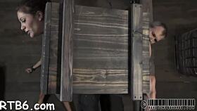 dominant woman dominates submissive in intense sadomasochistic session with whips and chains