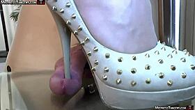 barefoot mistress has him by the balls with her feet