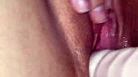 MILF plays with dildo on her pussy close up