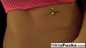 Hot milf Nikita Von James in solo fishnet action, showing her big tits and pussy.