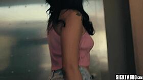 A guy interacts with a petite young woman with big breasts.