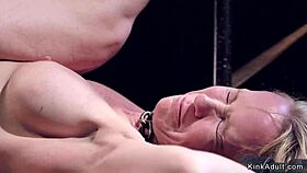 gagged milf in metal stock, whipped hard while fucking bondage slave.