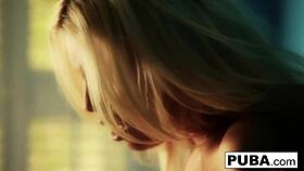 britney amber masturbates against the blue wall, flaunting her big tits and ass