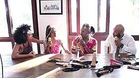 Passionate Black Couple In Sensual Lingerie And Sheer Red At Santa Caliente Event, Feeling Glamour And Beauty.