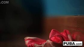 britney amber masturbates against the blue wall, flaunting her big tits and ass