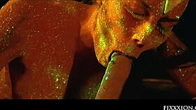 The glow in the dark goddess fingers her shaved pussy with a dildo.