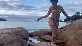 Shibari bondage performed in public with small tits exposed.