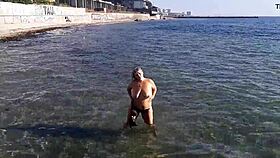 milf teases with candy body on public beach