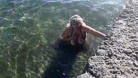 milf teases with candy body on public beach