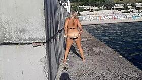 milf teases with candy body on public beach