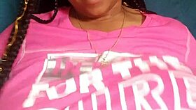 Ebony woman with green eyes and big tits chats casually.