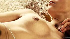 Delphine enjoys solo fingering on the sofa