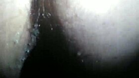 A person explores fisting with a large toy fist in a private session