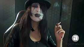 Goth girl shows smoking styles in a fetish setting