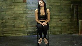 Lesbian Dominatrix Interacts with Bound Submissive in BDSM Scene