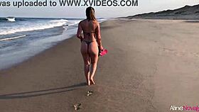 Blonde girl on the beach banging her fan hard