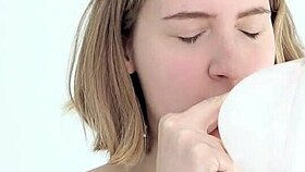 Young babe intensely blows and pops her first balloon