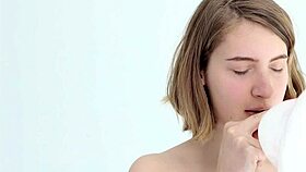 Young babe intensely blows and pops her first balloon