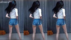 Korean cutie dances sensually with big tits on a magic phone display