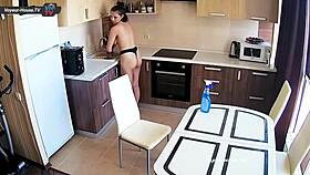Big tits beauty with pierced nipples cleans kitchen topless for fun.