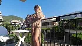Nude on a public balcony, flashing my body over the busy road below
