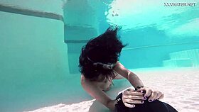 Brita piskova masturbates her tight pussy underwater in the pool