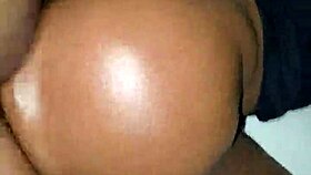 Ebony woman bent over in oiled doggystyle position with moaning