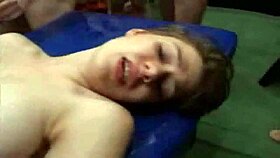 Two young women participate in a group activity with multiple men