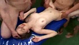 Two young women participate in a group activity with multiple men