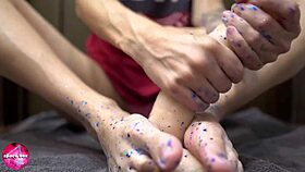 Beautiful woman gives a sensual footjob to a man with a rubber cock - foot fetish