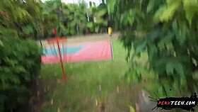 two people engage in intimate activities in a public park despite passersby