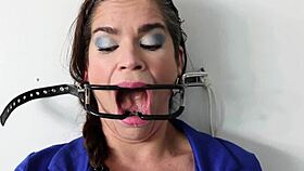 extreme gag predicament has him nailed to the wall in sloppy spitting action