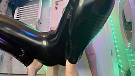 The teen amateur masturbates and uses a big dildo in latex leather.