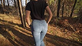 Hey, see this hot milf in tight jeans teasing her ass outdoors in woods