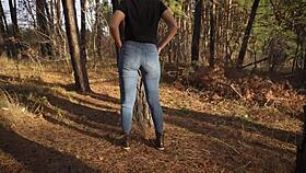 Hey, see this hot milf in tight jeans teasing her ass outdoors in woods