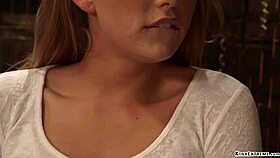 The blonde woman is bent over and bound while being whipped