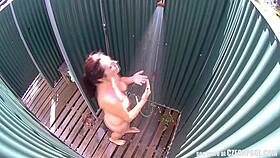brunette milf relaxes in a public pool shower