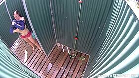 brunette milf relaxes in a public pool shower