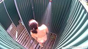 brunette milf relaxes in a public pool shower