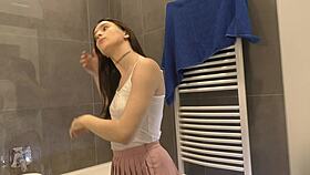 Skinny brunette shows assets in pink mini skirt