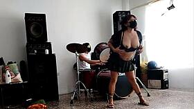 She strips and dances, showing her curvy ass for their drum beats.