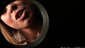 Nikki Delano eagerly performs a handjob and blowjob on Ralph Long at the gloryhole, leading to a cumshot.