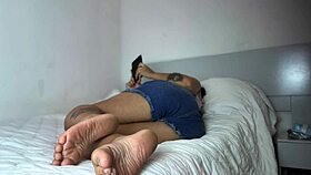 A curvy latina girl relaxes on the bed with a book and lets out a soft fart.