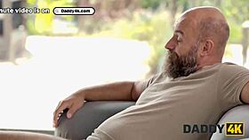 Man, this slutty gf is sucking cock and stripteasing for another right in the same room!