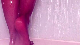 Teasing nylon feet in the wet shower, stockings on toes.